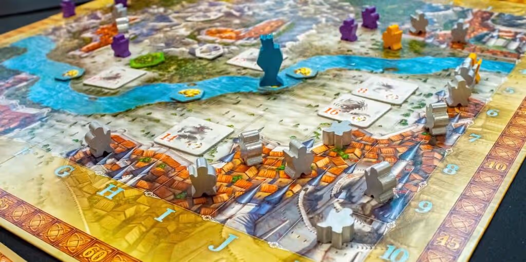 Adventure Land board game displayed with board, character cards, dice, and tokens arranged to showcase game components