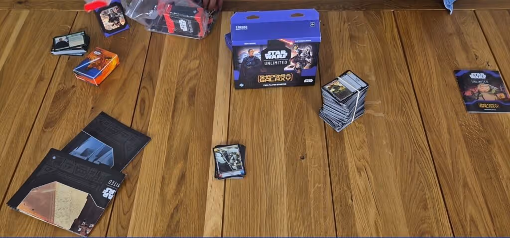 Star Wars Unlimited card game components and box on a wooden table